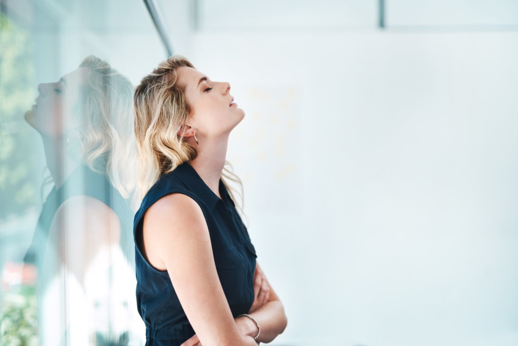 Trying to drag herself out of the doom and gloom Shot of a young businesswoman looking stressed out in an office